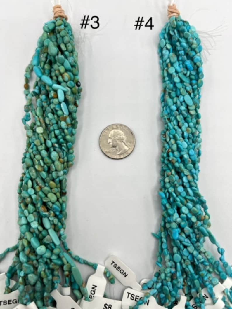 May include: Two strands of turquoise chip beads, labelled #3 and #4. The beads are a mix of light and dark blue turquoise, with some brown inclusions. The beads are strung on a white cord and are approximately 18 inches long.