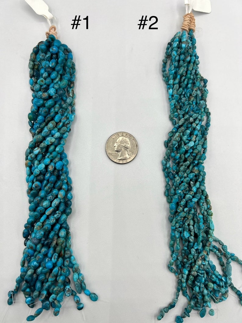 May include: Two strands of turquoise beads, each about 18 inches long, are displayed next to a US quarter for size comparison. The beads are a light blue color with brown flecks and have a slightly irregular shape.