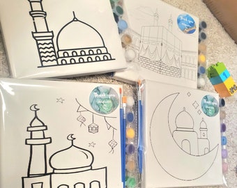 May include: Four paint-by-number canvases featuring Islamic designs. The canvases depict a mosque, a crescent moon with a mosque, the Kaaba, and a mosque with lanterns. Each canvas is packaged with paintbrushes and paint pots.