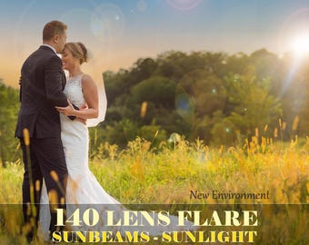 May include: A couple in wedding attire standing in a field of tall grass. The groom is kissing the bride on the forehead. The background is a blurred image of trees and a bright sun.