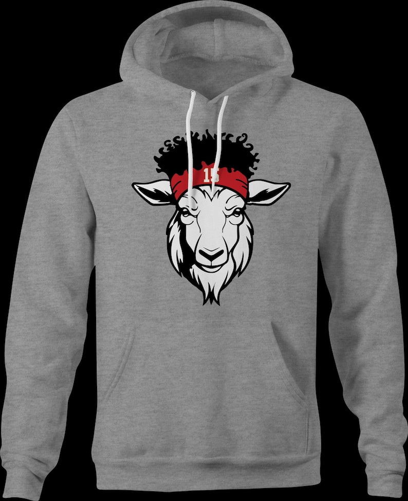 May include: A grey hooded sweatshirt featuring a black and white goat head graphic. The goat is wearing a red headband with the number 15 on it.