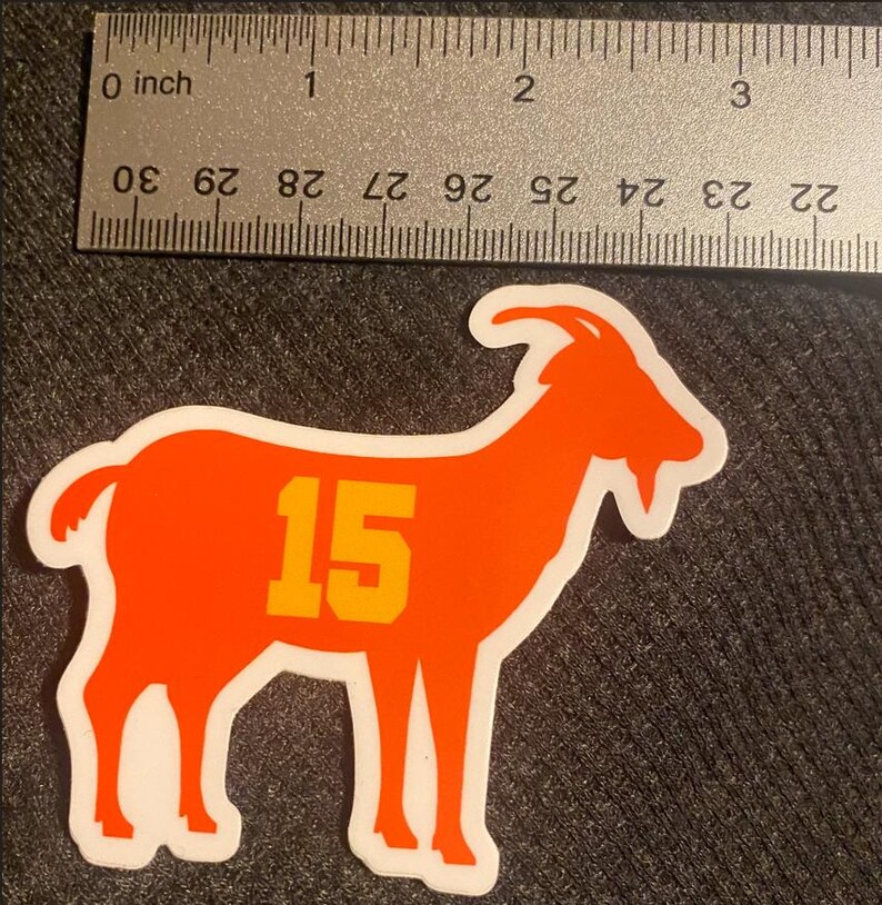 May include: Orange goat silhouette sticker with the number 15 in yellow on the side.