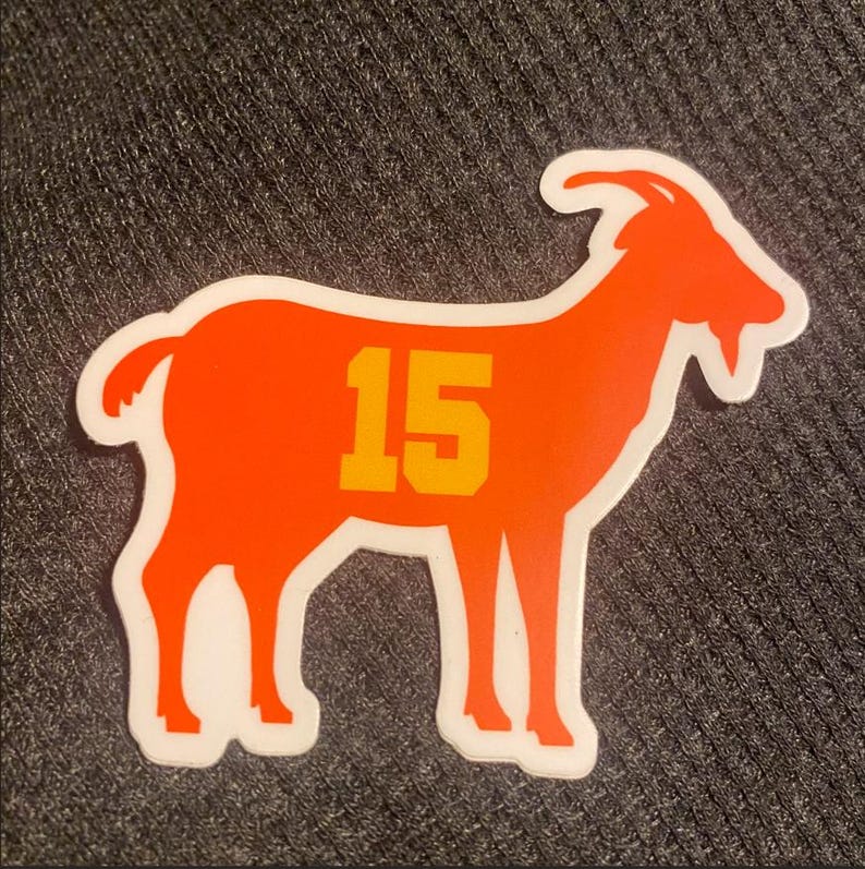 May include: Orange goat silhouette sticker with the number 15 in yellow on the side.