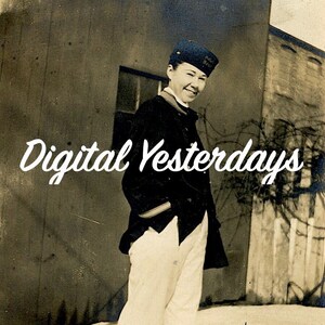 May include: A black and white photograph of a person wearing a navy blue jacket and white trousers. The person is standing in front of a building with the text "Digital Yesterdays" written in white cursive.