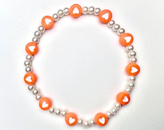 Pastel orange heart beaded bracelet, with plastic pearl beads, 7 inch stretchy beaded bracelet