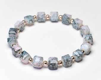 Black and gray glass beaded bracelet, with rose gold spacer beads, 6.5 inch stretchy beaded bracelet