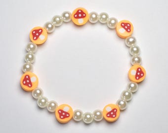 Red and orange mushroom clay beaded bracelet, with pearl round beads, 6.5 inch stretchy beaded bracelet