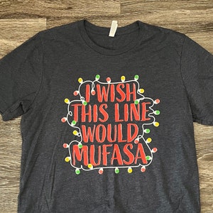 May include: A dark gray t-shirt with a red and white graphic print of a string of Christmas lights with the text "I wish this line would Mufasa".