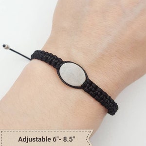 May include: Black braided bracelet with a clear quartz oval charm. The bracelet is adjustable from 6 to 8.5 inches. 13x10mm Clear Quartz.