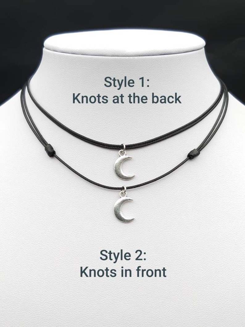 May include: Two black cord necklaces with silver crescent moon charms. The necklaces are shown in two styles: one with knots at the back and one with knots at the front. "Style 1: Knots at the back" and "Style 2: Knots at the front" are written in white text on a white background.