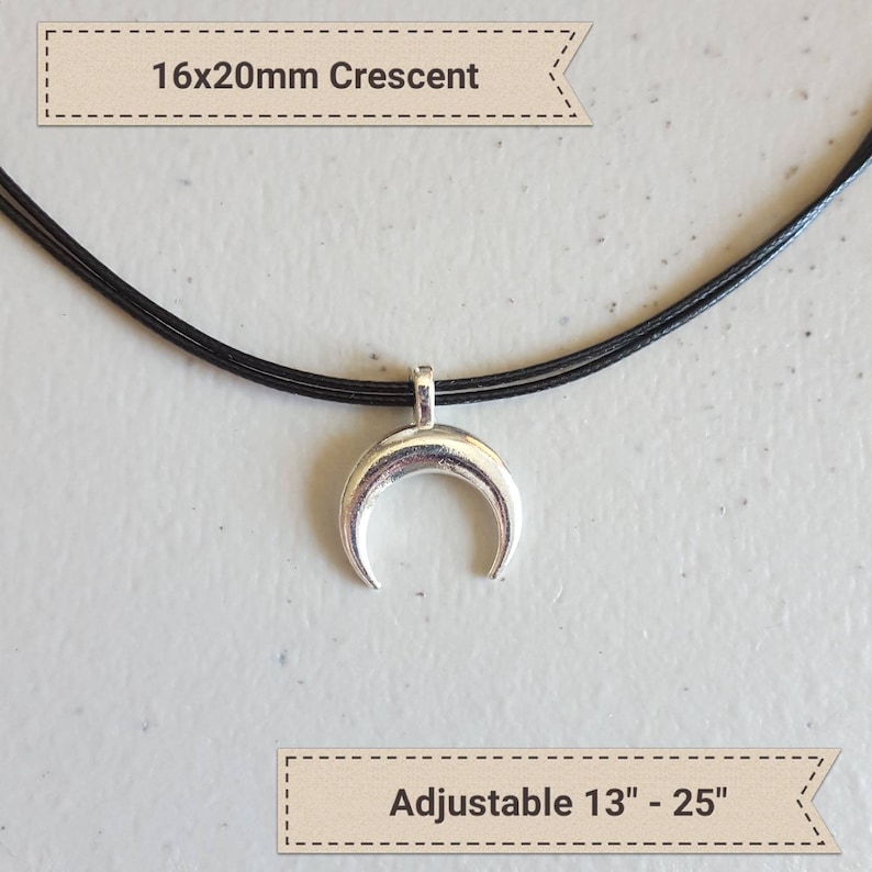 May include: A silver crescent moon pendant necklace on a black adjustable cord. The pendant is 16mm by 20mm and the cord is adjustable from 13 to 25 inches.