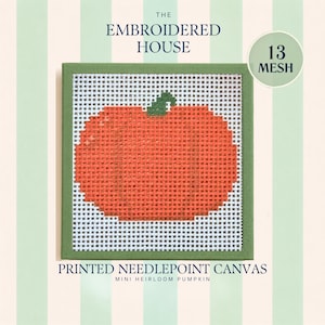 May include: A square needlepoint canvas featuring a printed orange pumpkin design with a green stem. The canvas is framed in a green border and labeled 13 MESH. Text on the image reads THE EMBROIDERED HOUSE, 13 MESH, and PRINTED NEEDLEPOINT CANVAS MINI HEIRLOOM PUMPKIN.
