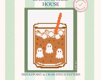May include: A cross stitch pattern titled The Embroidered House featuring a pixelated illustration of a glass filled with brown liquid, ice cubes, and three small white ghosts, with an orange straw, on a white grid background with green borders.