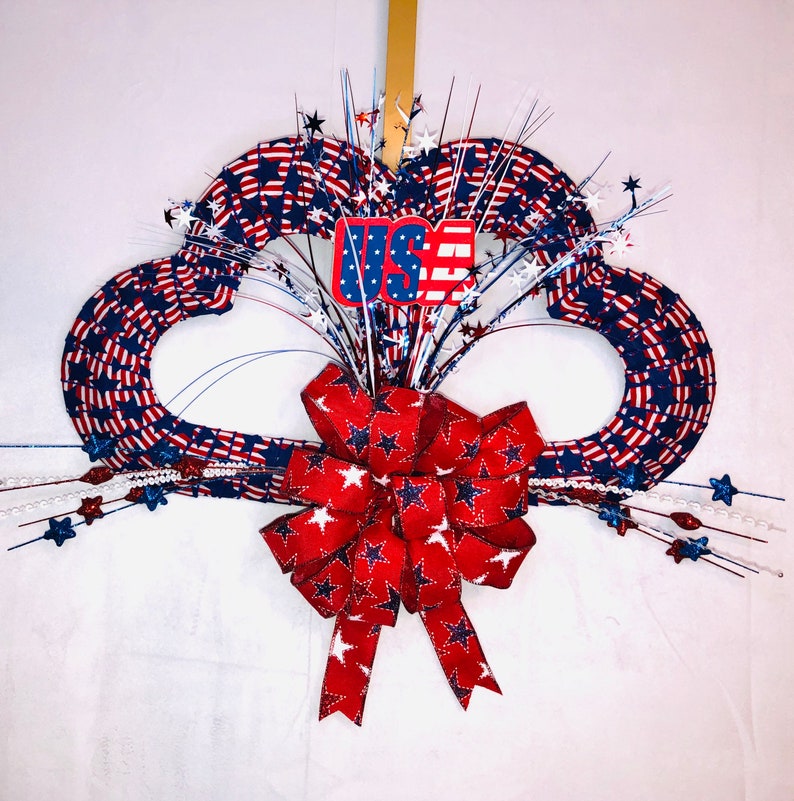 Spread twice the patriotic cheer with this fabulous double heart wreath you can purchase at Etsy. Or try to make your own. Here are some darling ideas for 4th of July DIY door wreaths. You will love them!