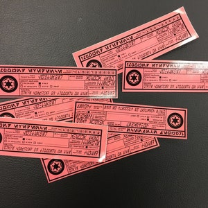 May include: A stack of pink paper cards with black text and a black and white symbol. The text on the cards reads "1200007 ҮИРИИЧИ4152126802 NWROW 10 47000074 ONNOM NUROW 07XYW 40M217207 30 47000ти Дикни ДИР МИ٤ ٤٨٨٨VIOODIL БИЛО WORLDDULT AS EKOLIPRON MANLO 1200007 МҮИРИЛЧИ4152726599 MONNA MORLANDOLT AS ERTLUPION MAXLO 07KYW 4041727 87 +7000VND NOME 1200007 МҮИРМИЧИ 10 BOUNTY NOW"