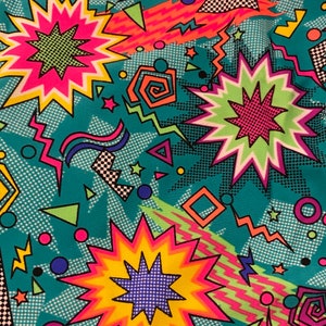 May include: A teal background with a colorful geometric pattern. The pattern includes stars, swirls, and zigzags in pink, yellow, green, and black.