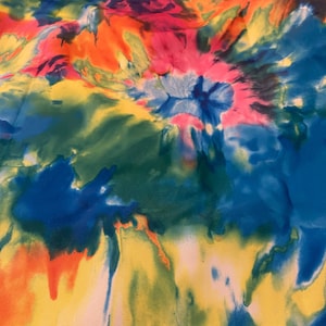 May include: A colorful tie-dye fabric with shades of blue, green, yellow, orange, pink, and red. The fabric has a swirling pattern.