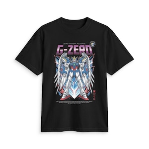 May include: A black short-sleeve t-shirt featuring a graphic print of a white, blue, and red robot with large wings. The text "ZERO SYSTEM: ACTIVATE" and "G-ZERO" appears above the robot, with additional small text and Japanese characters below.