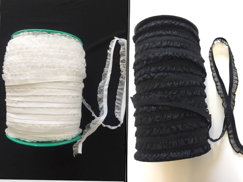 May include: Two spools of ruffled elastic trim, one white and one black. The trim is made of a soft, stretchy material and has a delicate, ruffled edge.