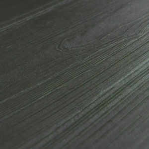 May include: Close-up of a dark gray wood grain surface. The wood grain is visible and has a slight sheen.
