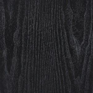 K&ouml;nnte beinhalten: Schwarze Holzmaserung mit einer dunklen, fast schwarzen Oberfl&auml;che. Die Holzmaserung ist sichtbar und hat einen dezenten Glanz.