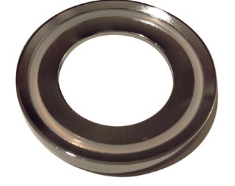 May include: A silver-colored metal ring with a smooth, polished finish. The ring has a slightly raised edge and a smaller inner ring.