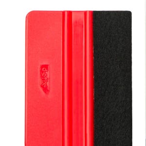May include: Red plastic squeegee with a black felt edge. The squeegee has a "Decalfix" logo on the front.