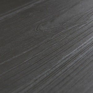 May include: Close-up of a dark gray woodgrain surface.