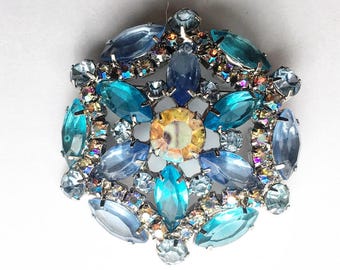 Gorgeous sparkly silver tone Vintage pin - blue aurora borealis rhinestones, multiple shades of blue and a yellow stone in the center