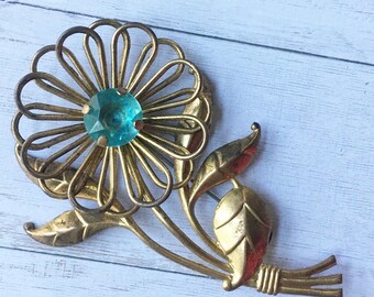 Gold tone metal flower with blue/teal/aquamarine/light blue flower center- garden, nature, beauty