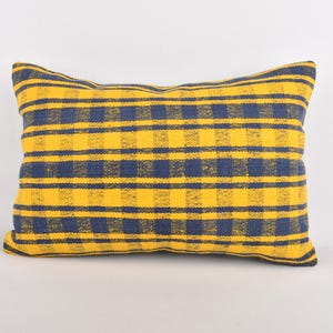May include: A yellow and blue checkered throw pillow. The pillow is made of a soft, woven fabric.