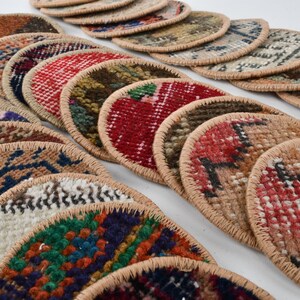 May include: A collection of colorful round woven coasters with a beige trim. The coasters feature various patterns and designs.