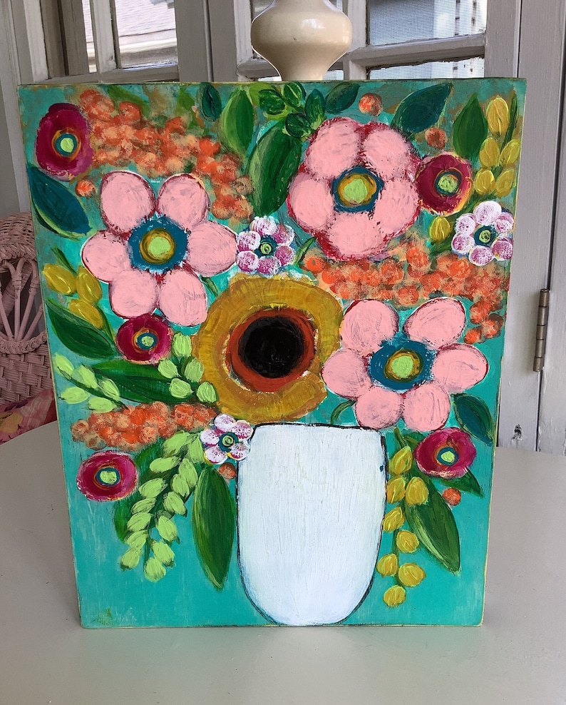 May include: A painting of a bouquet of pink, yellow, and red flowers in a white vase. The flowers are painted in a whimsical style with bold colors and textures. The background is a bright turquoise.