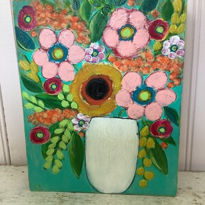 May include: A rectangular painting on a wooden panel featuring a bouquet of stylized flowers in a white vase against a vibrant turquoise background. The artwork displays pink, yellow, orange, and red blossoms with green leaves and textured brushstrokes.