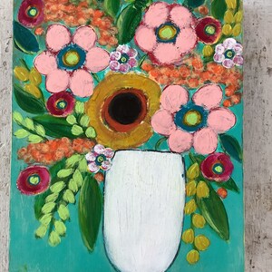 May include: A rectangular painting on a wooden panel featuring a white vase filled with a vibrant floral arrangement. The bouquet includes large pink flowers, a central dark-centered yellow flower, and small orange clusters against a teal background.