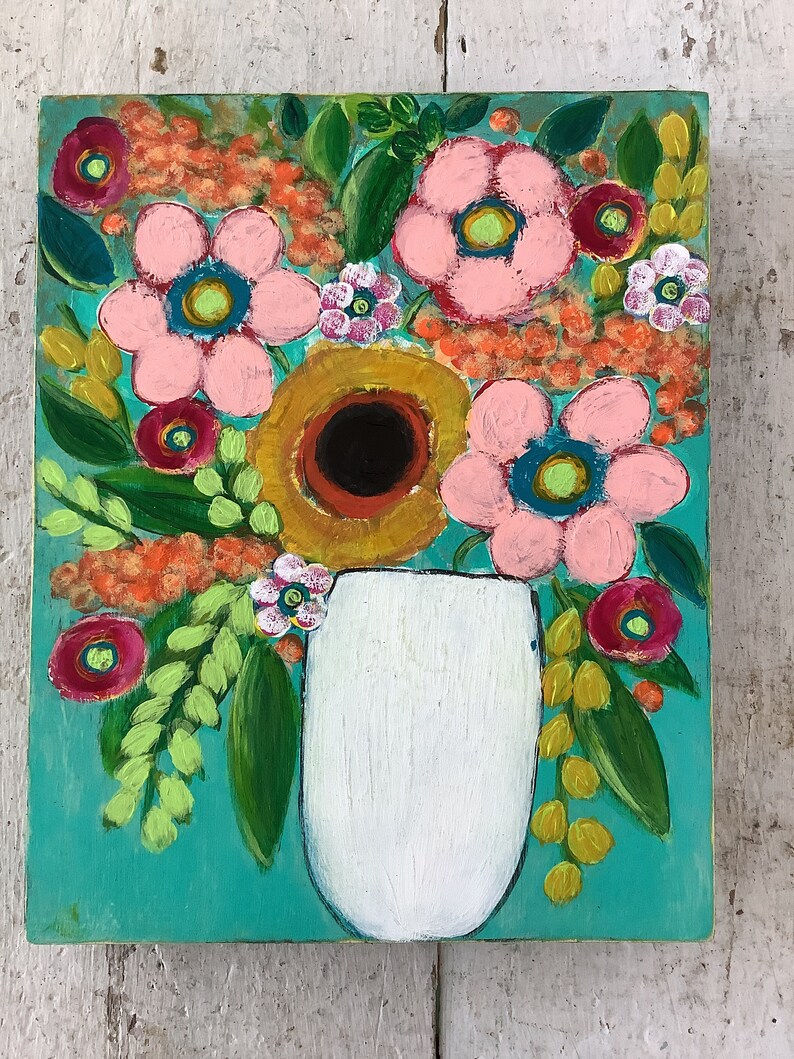 May include: A rectangular painting on a wooden panel featuring a white vase filled with a vibrant floral arrangement. The bouquet includes large pink flowers, a central dark-centered yellow flower, and small orange clusters against a teal background.