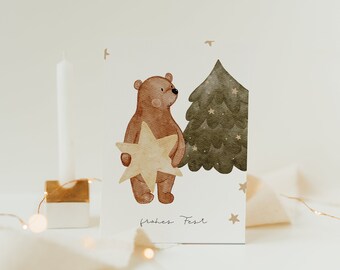 May include: A watercolor illustration of a brown bear holding a gold star in front of a green Christmas tree. The text "frohes Fest" is written below the bear and tree.