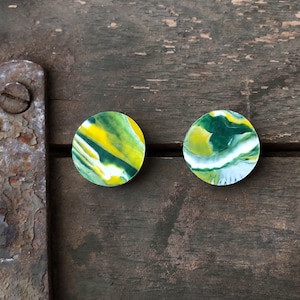 May include: Two round, green, yellow, and white marbled resin earrings.