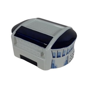 May include: A white ceramic money box shaped like a stadium with blue and white details. The roof of the stadium is blue and has a white circle in the centre. The sides of the stadium are white with blue details.