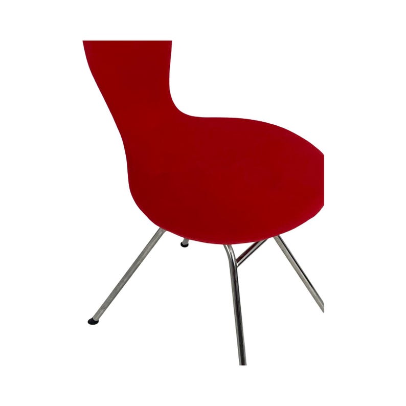 May include: A red chair with a curved back and a chrome frame. The chair has a simple, modern design.