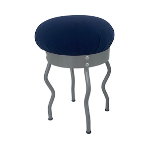 May include: A blue velvet stool with a silver metal base and four wavy legs.