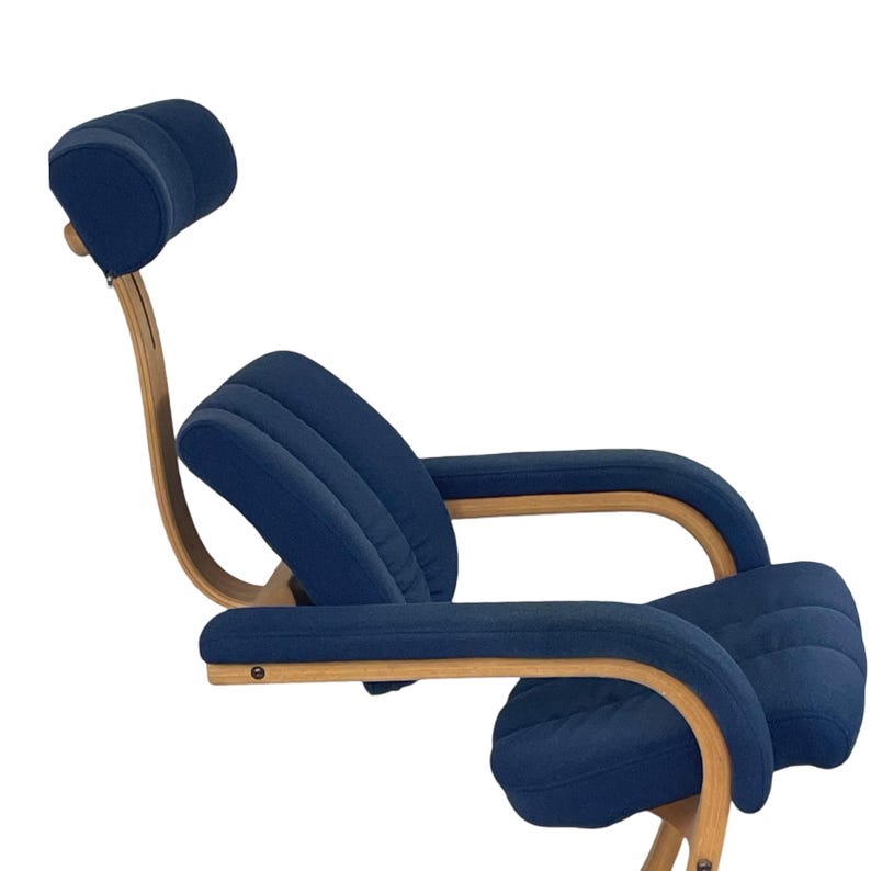 May include: A blue fabric reclining chair with a wooden frame and a headrest. The chair has a curved design and is made for relaxing.