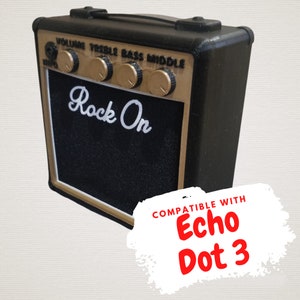 May include: Black and gold guitar amplifier with the words "Rock On" printed on the front. Compatible with Echo Dot 3.