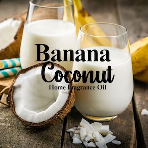 May include: Two glasses of milk with a half coconut and a banana on a wooden surface. The text "Banana Coconut Home Fragrance Oil" is displayed on the image.