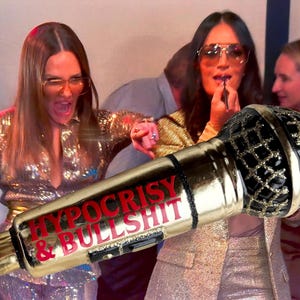 May include: A gold-colored microphone ornament featuring a black mesh head and the red text HYPOCRISY & BULLSHIT printed on the handle. The microphone has a metallic finish and includes a gold hanging string attached to the top.