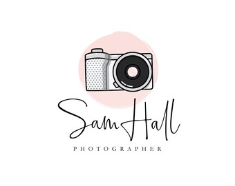 May include: A logo for a photographer named Sam Hall. The logo features a stylized camera icon in a pink circle with a white background. The text "Sam Hall Photographer" is written in a cursive font below the camera icon.