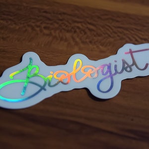May include: A white sticker with the word "Biologist" written in a rainbow holographic font.
