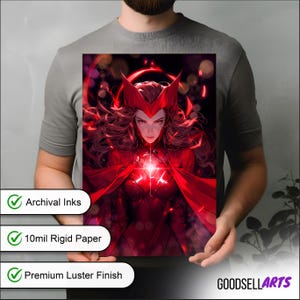 May include: A vibrant red artwork featuring a character with a red headpiece and flowing hair. The character is wearing a red costume and cape. The artwork is held by a person. The image has text that says "Archival Inks", "10mil Rigid Paper", and "Premium Luster Finish".