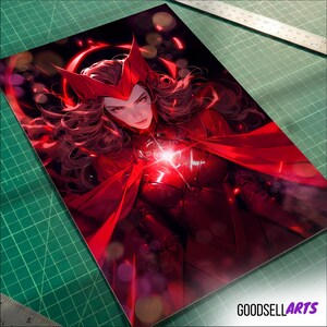 May include: A vibrant, red artwork featuring a character with a red headpiece and flowing hair. The character is depicted in a red costume, with a glowing light emanating from their chest. The artwork is on a rectangular print, with the text "GOODSELLARTS" visible.
