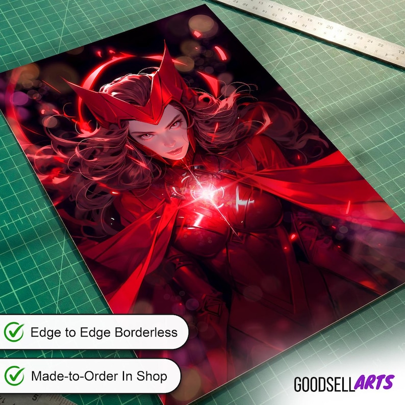 May include: A rectangular art print featuring a character with long dark hair wearing a red headpiece and red armor. A bright light glows from the chest area. The print is positioned on a green cutting mat next to a metal ruler showing inches.